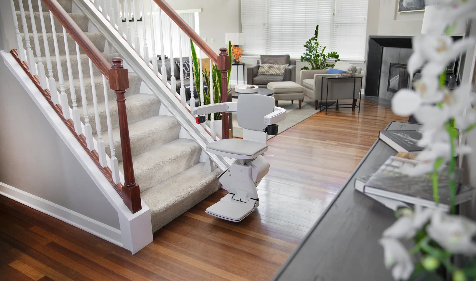 Bruno Elan SRE-5000 Standard stairlift at the bottom of an indoor staircase, ready to ride